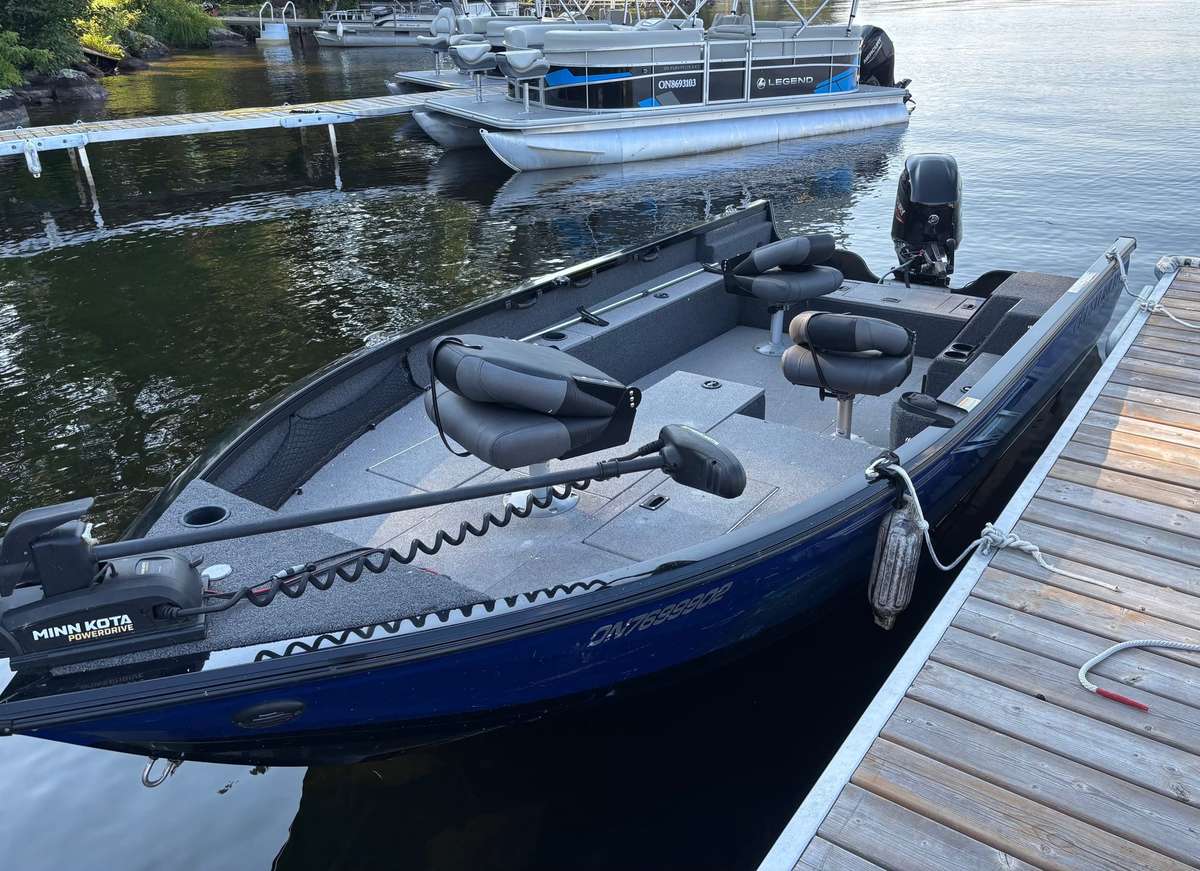 The Crestliner tiller boat at the dock